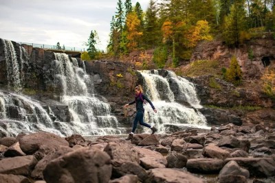 fall-hiking-in-front-of-waterfall-gooseberry-falls-state-park.jpg